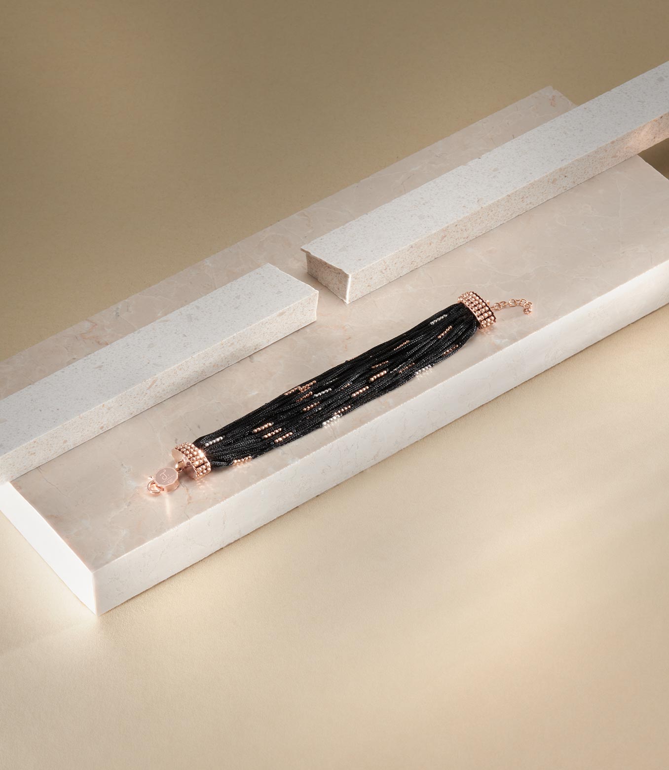 <p>Bracciale in oro rosa e bianco e seta nera</p>